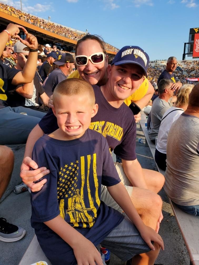 Brad and Mary Beth, hopeful adoptive parents through Spirit of Faith Adoptions with their nephew at a sporting event. 